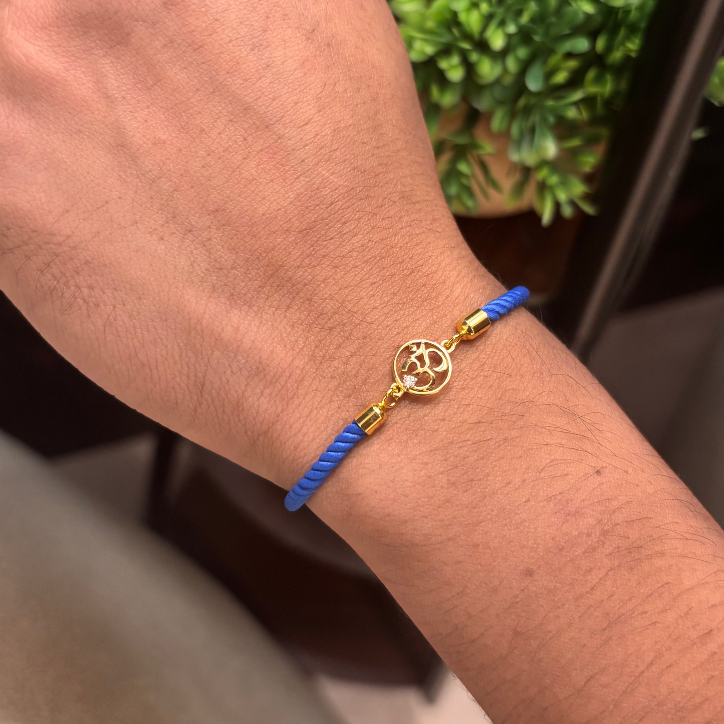 Blue rope men's bracelet with 18kt gold Om charm and diamond accent. An affordable gift for him under Rs. 15,000