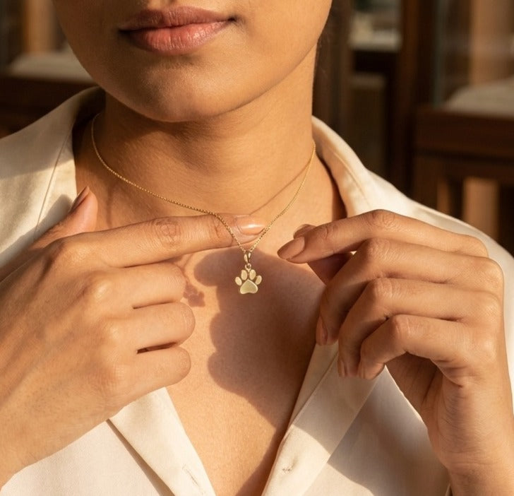 Caratly 18kt gold Paw Gold Pendant featuring a small, polished solid gold paw print charm on a delicate chain under Rs. 15,000