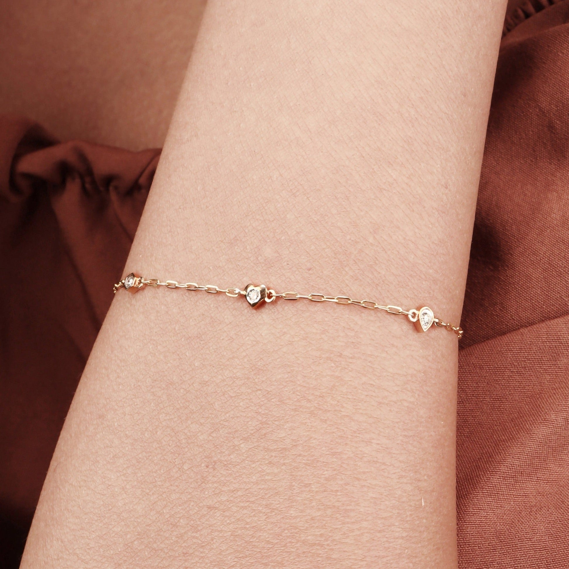 Caratly 18kt gold 4 Style Diamond Bracelet featuring a delicate chain with spaced diamond stations in various shapes including a heart and hexagon under Rs. 30,000