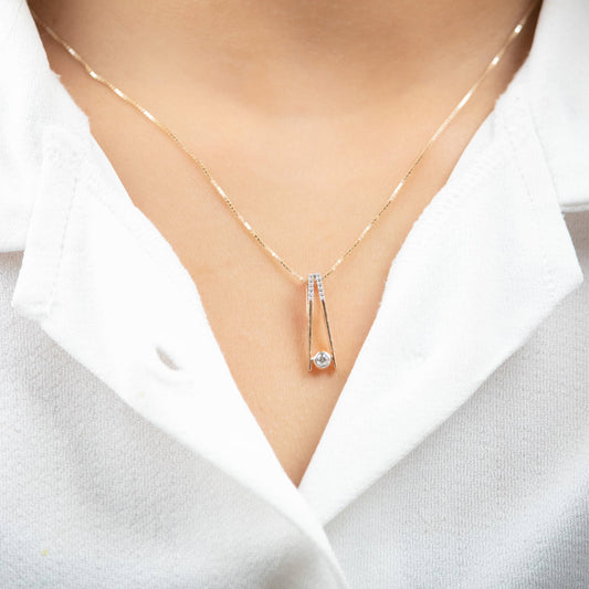 Caratly 18kt gold Elegant Diamond Pendant with 0.10ct solitaire diamond in a modern V-shape drop setting. Minimalist gift ideas for her under 40,000