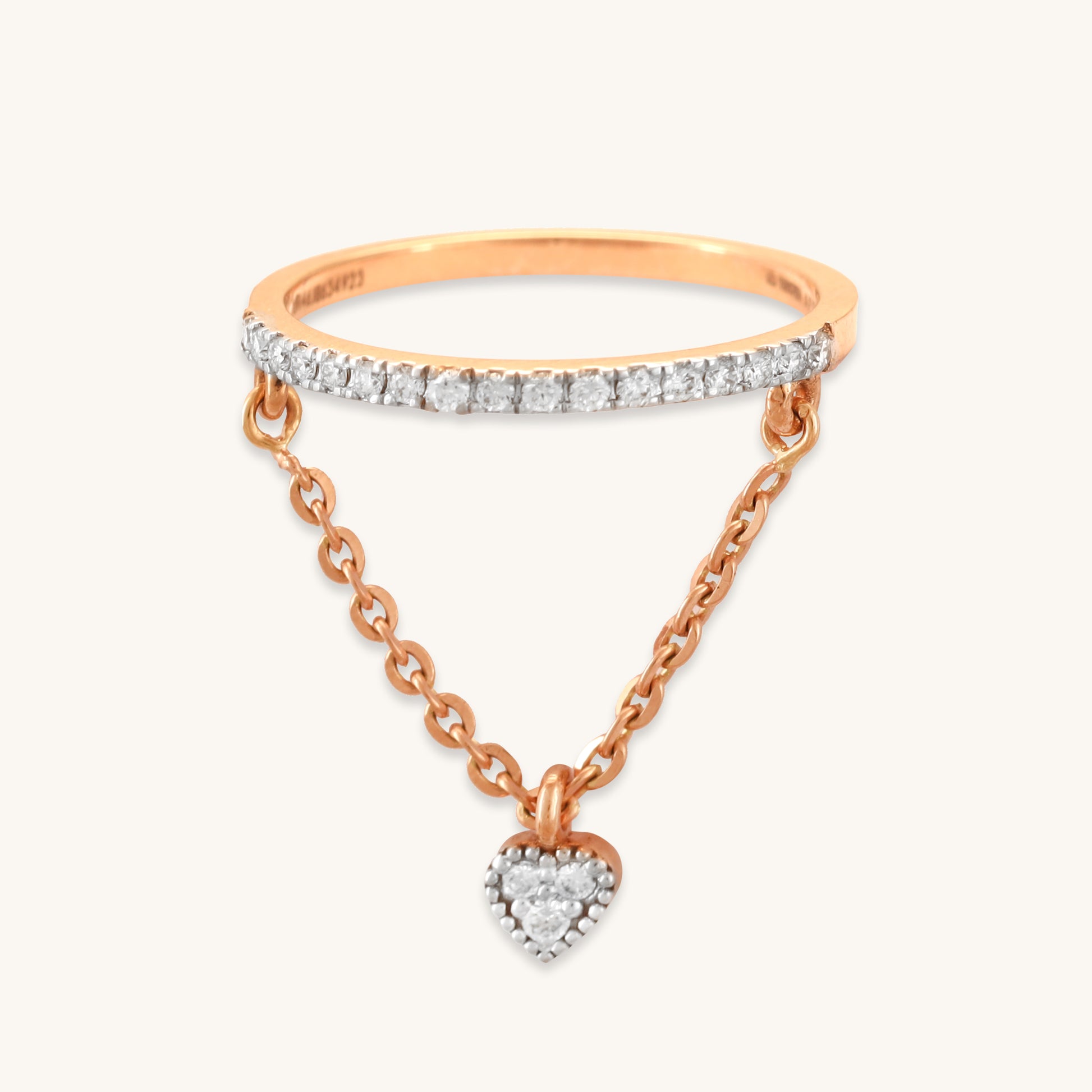 Caratly 18kt gold Dangling Diamond Ring featuring a straight pave diamond band with an attached draped chain holding a tiny diamond heart charm under Rs. 50,000