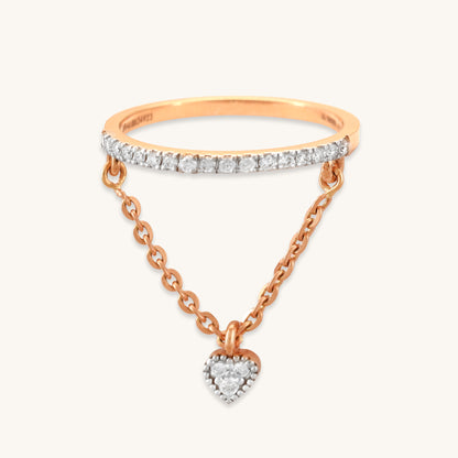 Caratly 18kt gold Dangling Diamond Ring featuring a straight pave diamond band with an attached draped chain holding a tiny diamond heart charm under Rs. 50,000