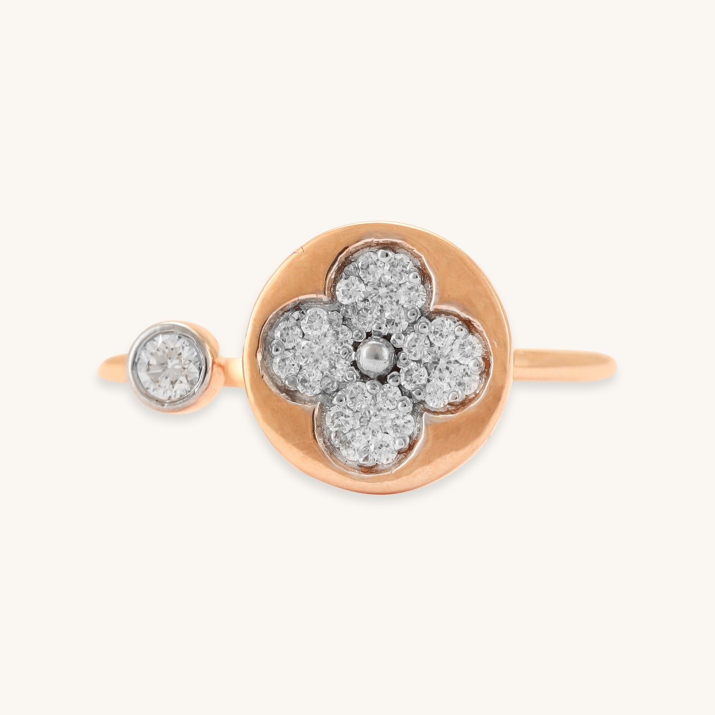 Caratly 18kt gold Flower Diamond Ring featuring an open bypass design with a diamond clover shape on one end and a small round bezel diamond on the other.