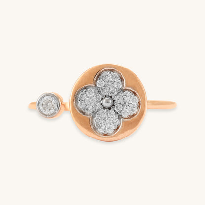 Caratly 18kt gold Flower Diamond Ring featuring an open bypass design with a diamond clover shape on one end and a small round bezel diamond on the other.