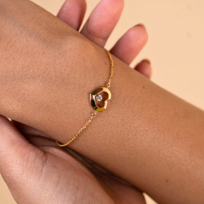 Caratly 18kt gold Love Diamond Bracelet featuring a polished open heart charm with a single bezel-set diamond floating in the center. Perfect minimal gift for her under Rs. 40,000