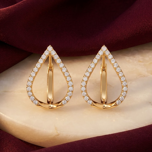 Gold open pear-shaped earrings outlined with pave diamonds. Luxe gift for her under Rs. 80,000