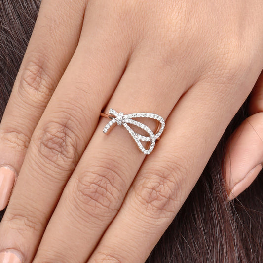 Caratly 18kt gold Bow Diamond Ring featuring an open, asymmetrical ribbon or bow shape fully outlined in pave diamonds