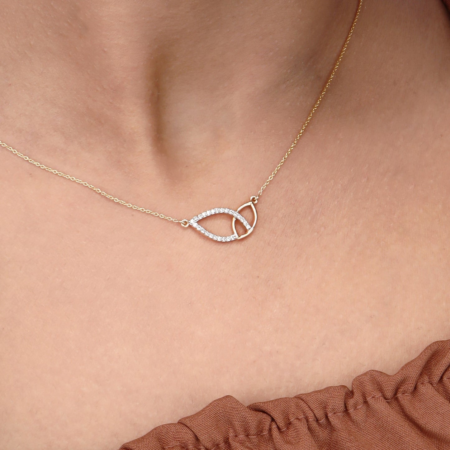 Caratly 18kt gold Leafy Diamond Necklace featuring two sideways overlapping open leaf shapes, one plain gold and one set with diamonds under Rs. 60,000