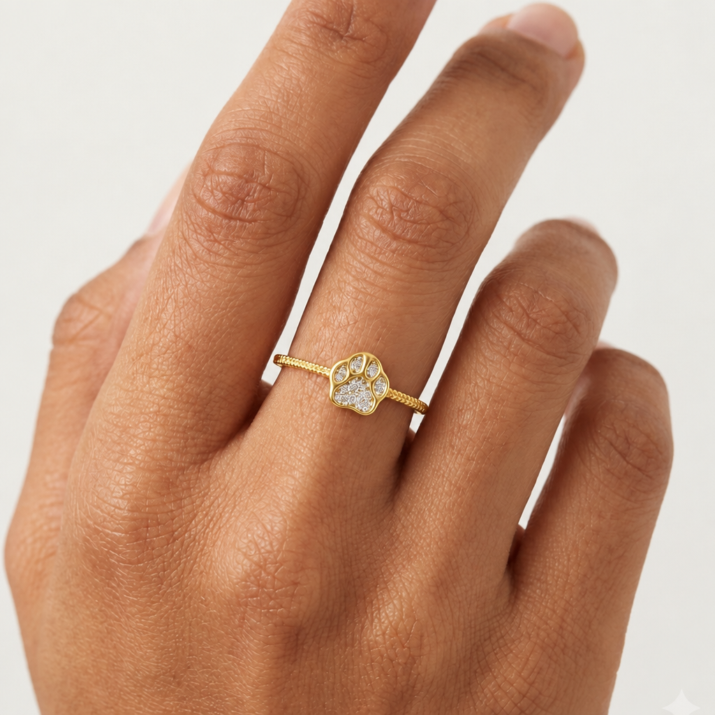 Gold ring with a heart-shaped paw print charm set with sparkling diamonds under Rs. 35,000