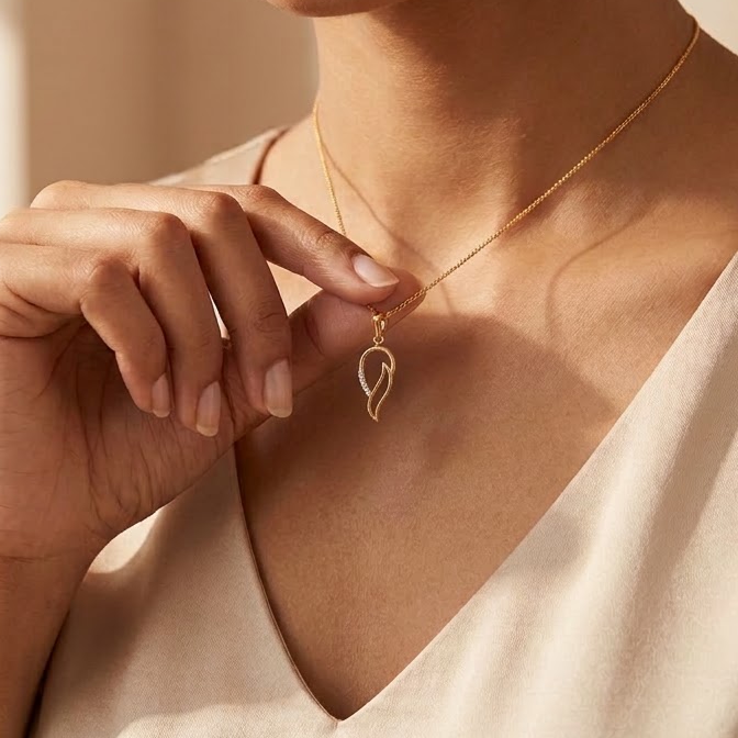 Gold conch shell-shaped pendant with a diamond-set curved detail, priced under Rs. 20,000