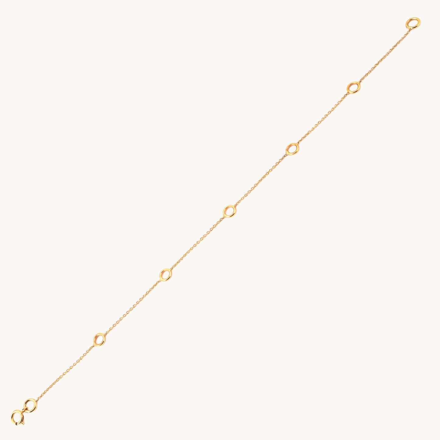 Caratly 18kt gold Charm Bracelet base chain featuring evenly spaced circular rings designed for clipping on personalized charms. Customizable gifts under Rs. 20,000