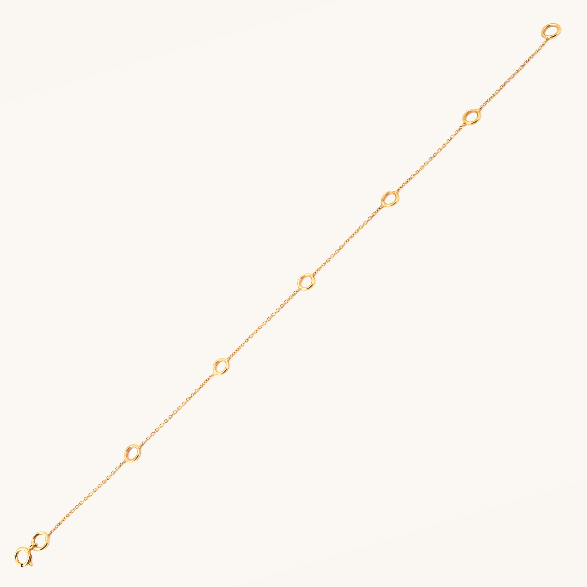 Caratly 18kt gold Charm Bracelet base chain featuring evenly spaced circular rings designed for clipping on personalized charms. Customizable gifts under Rs. 20,000