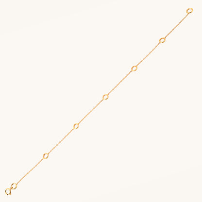 Caratly 18kt gold Charm Bracelet base chain featuring evenly spaced circular rings designed for clipping on personalized charms. Customizable gifts under Rs. 20,000