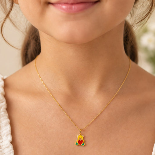 Gold enamel teddy bear pendant holding a red enamel heart, price under Rs. 25,000