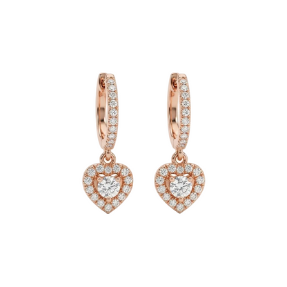 Rose gold huggie hoop earrings with a dangling pave diamond heart charm. Luxe and elegant gifts under Rs. 80,000