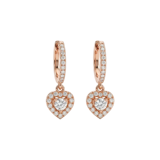 Rose gold huggie hoop earrings with a dangling pave diamond heart charm. Luxe and elegant gifts under Rs. 80,000