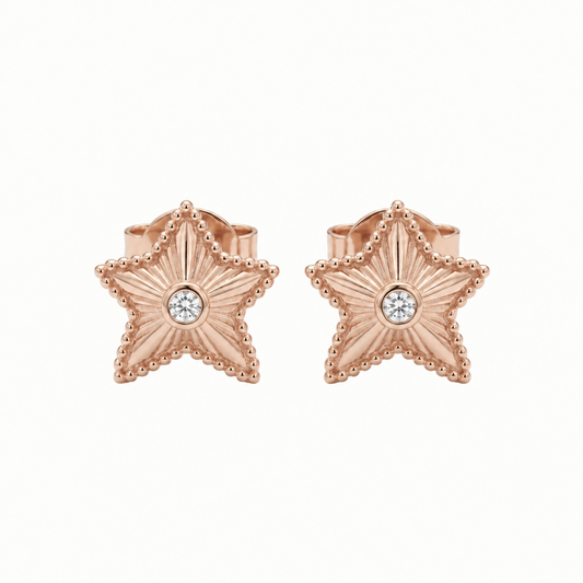 Rose gold textured star stud earrings with a sparkling stone at center. Priced under Rs. 35,000