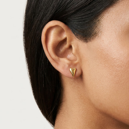 Polished gold heart-shaped stud earrings with a puffed, glossy finish. Minimal and cute gifts for her under Rs. 20,000