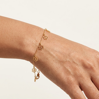Delicate rose gold vertical chain bracelet with small flower and bead station charms priced under Rs. 35,000