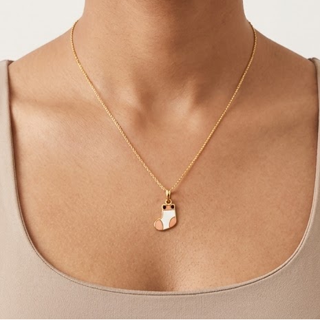 Gold pendant shaped like a colorful striped sock. A cute and minimal gift for kids under Rs. 15,000