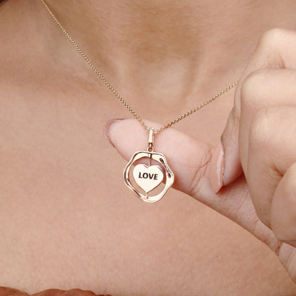 Caratly 18kt gold Love Gold Pendant featuring an organic wavy outer ring and a spinning inner circle engraved with the word LOVE under Rs. 50,000