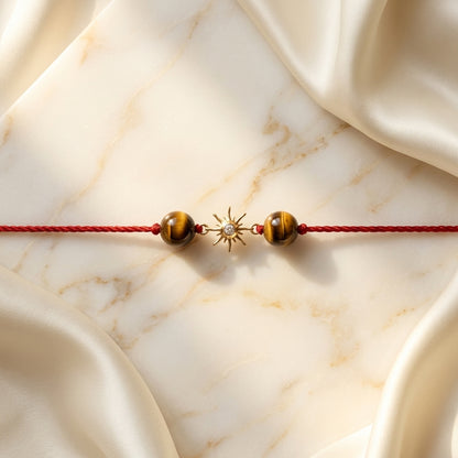 Gold sun diamond Rakhi with Tiger's eye beads.