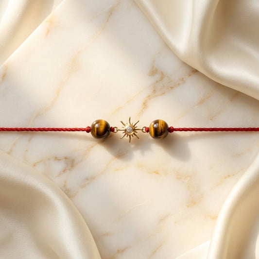 Gold sun diamond Rakhi with Tiger's eye beads.