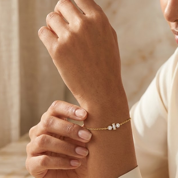 Gold chain bracelet with three sparkling diamond stones set at the center priced under Rs. 50,000