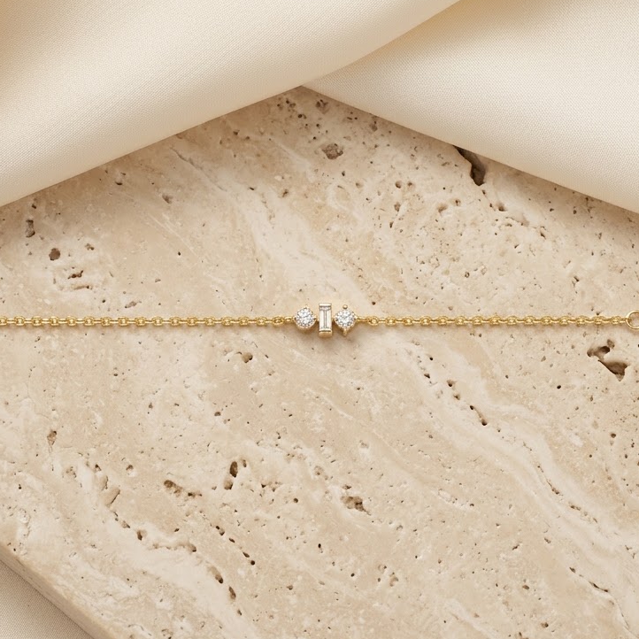 Gold chain bracelet with three sparkling diamond stones set at the center priced under Rs. 50,000