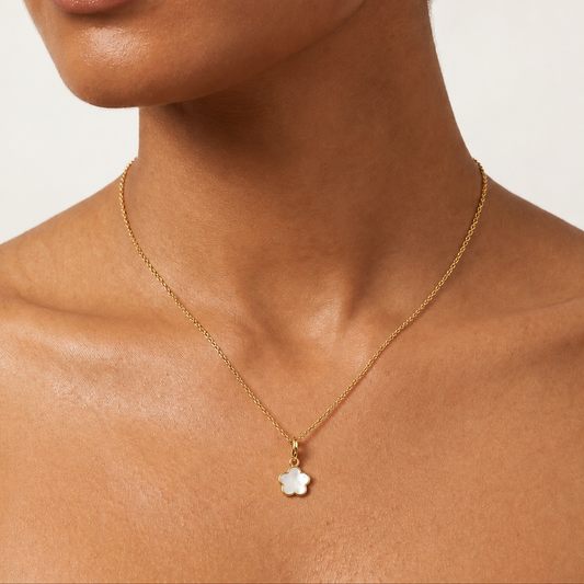 Gold flower-shaped pendant with a white mother-of-pearl inlay. Cute minimal gifts under Rs. 15,000