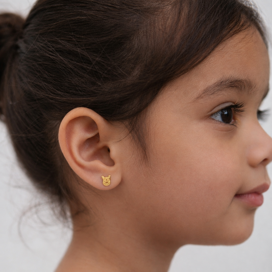 Pair of gold stud earrings shaped like Winnie the Pooh's face. Minimal and cute gifts under Rs. 20,000
